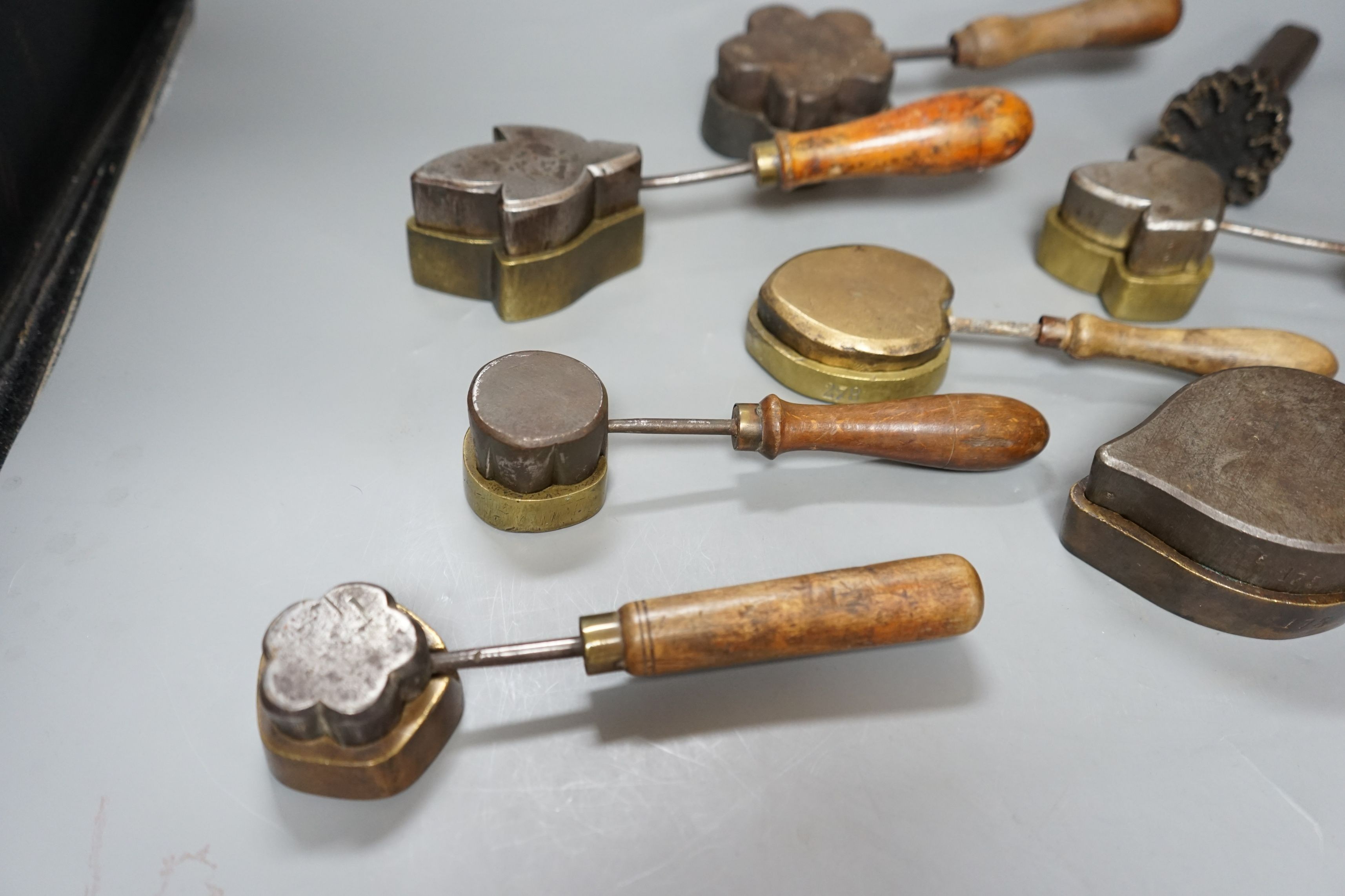 A collection of eight 19th century cast metal floral moulds, possibly for embossing silk